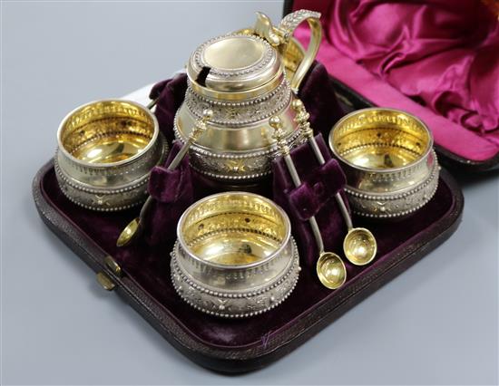 A cased Victorian parcel gilt silver five piece condiment set with five spoons, by George Fox, London 1876/7.